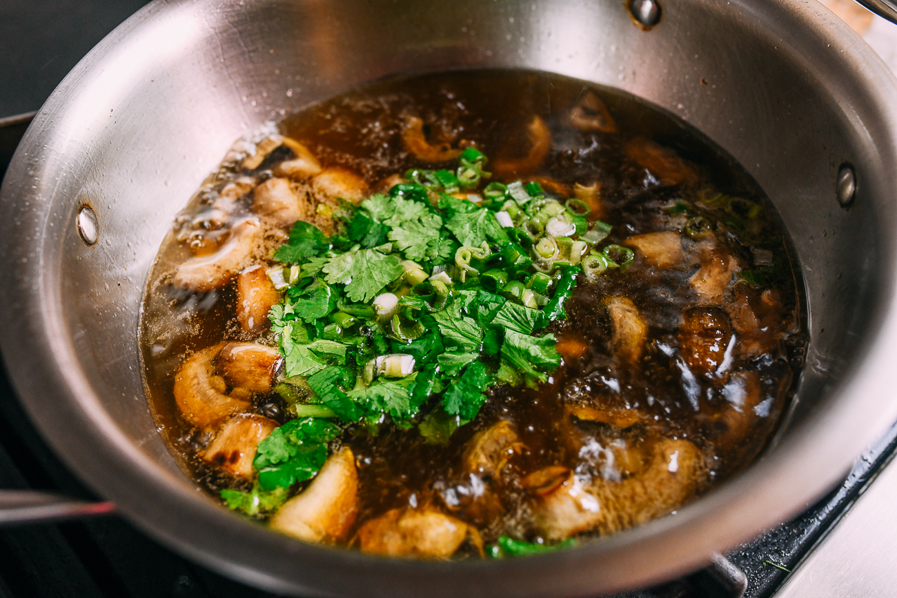 Adding cilantro and scallions to mushroom soup