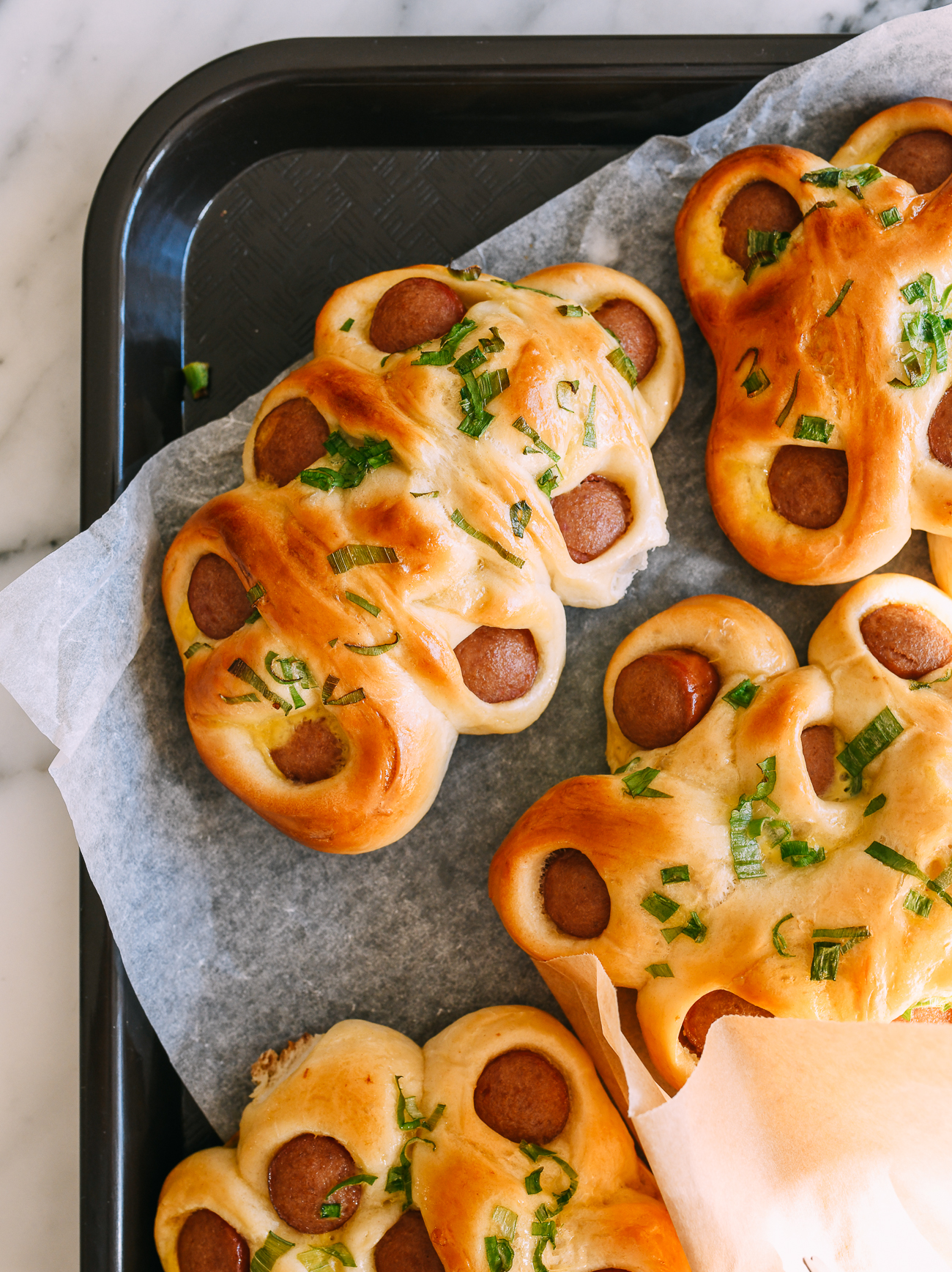 Flower hot dog buns on paper-lined tray