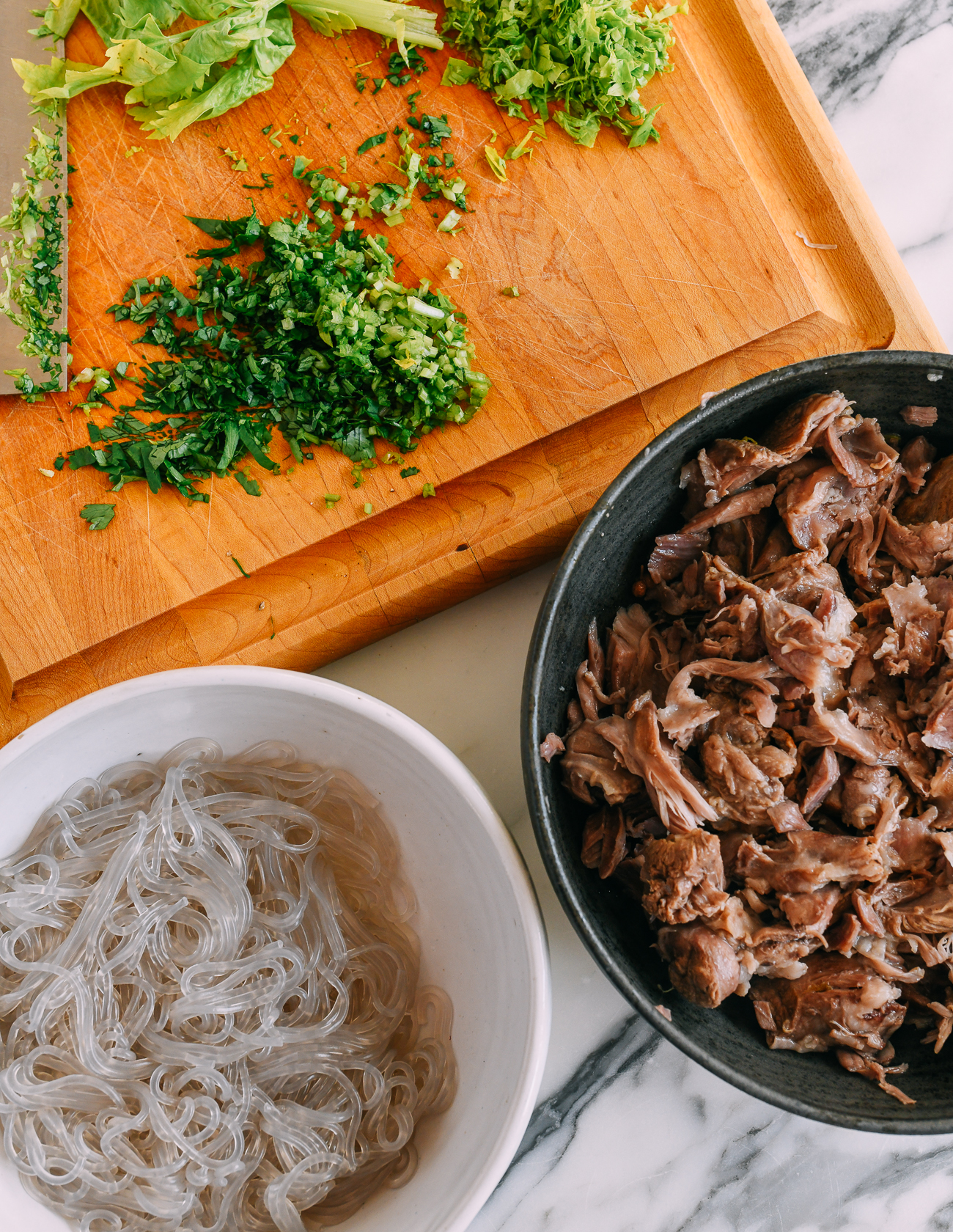 Boiled sweet potato glass noodles, chopped cilantro and celery, and lamb meat