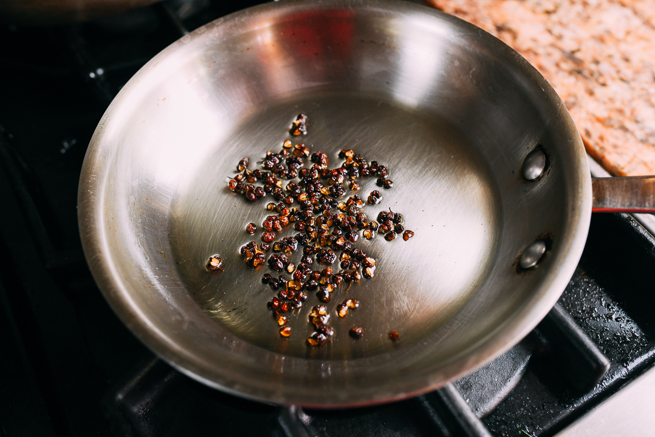 Sichuan peppercorns in oil in saucepan