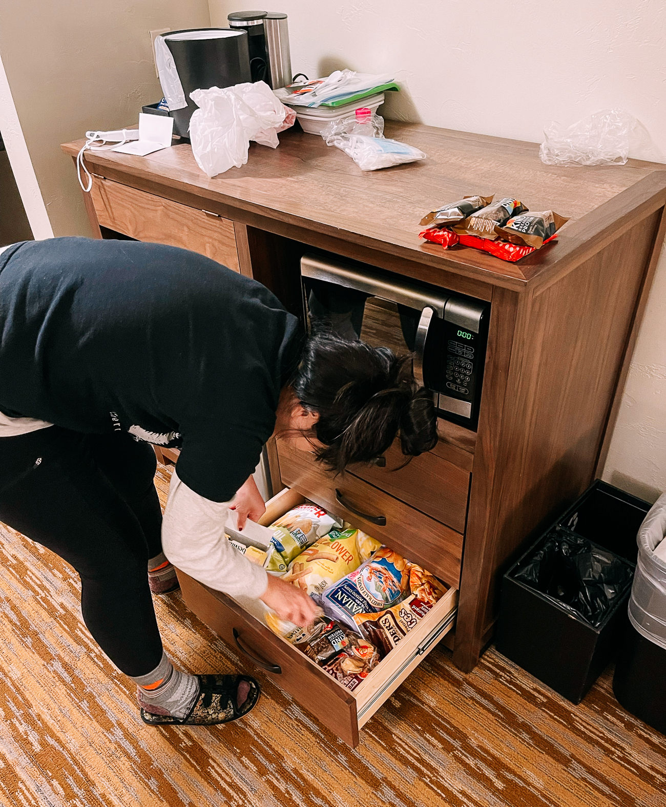 Sarah organizing the trip pantry in the hotel room