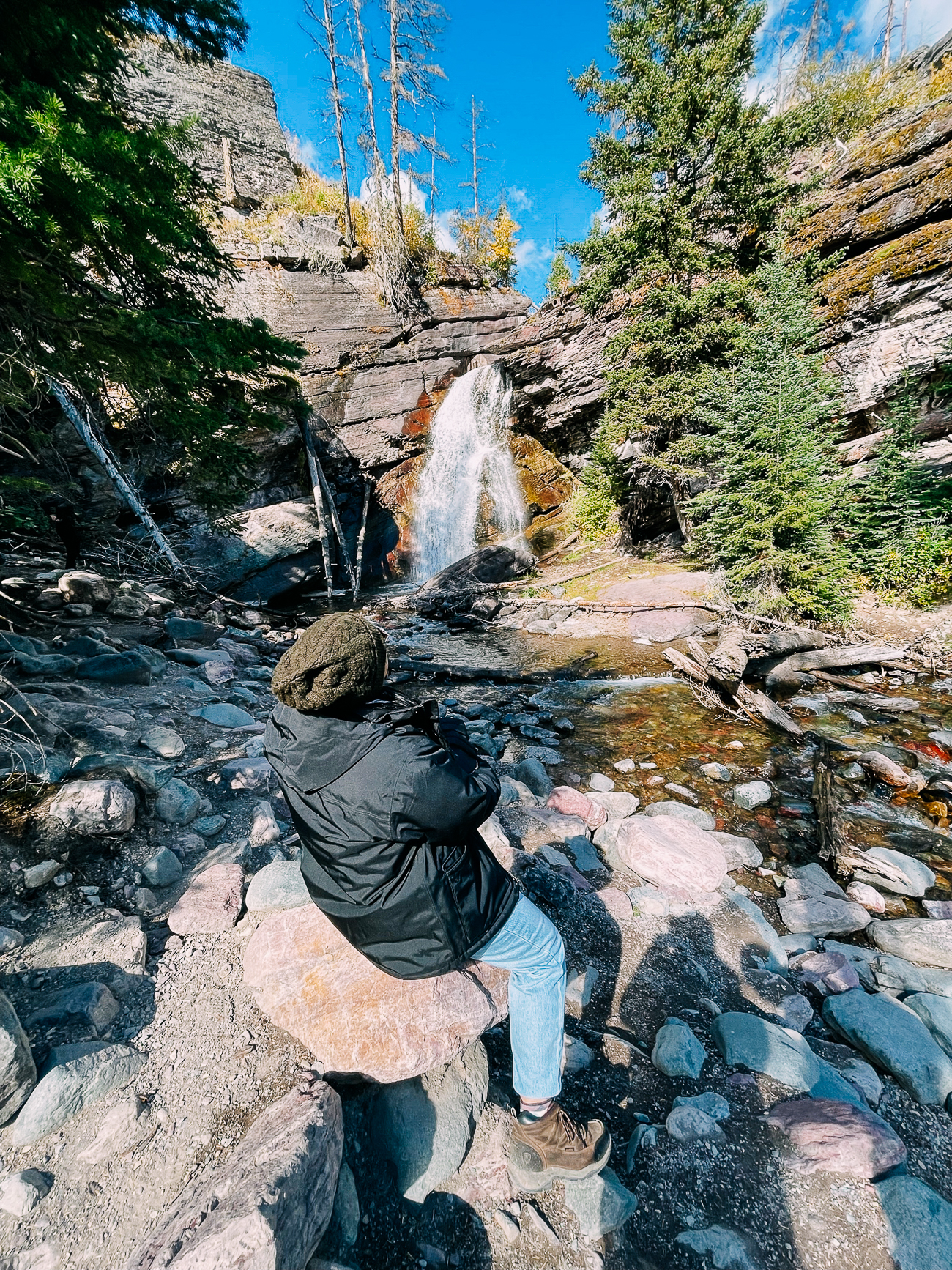 Sitting in front of Baring Falls in Glacier National Park