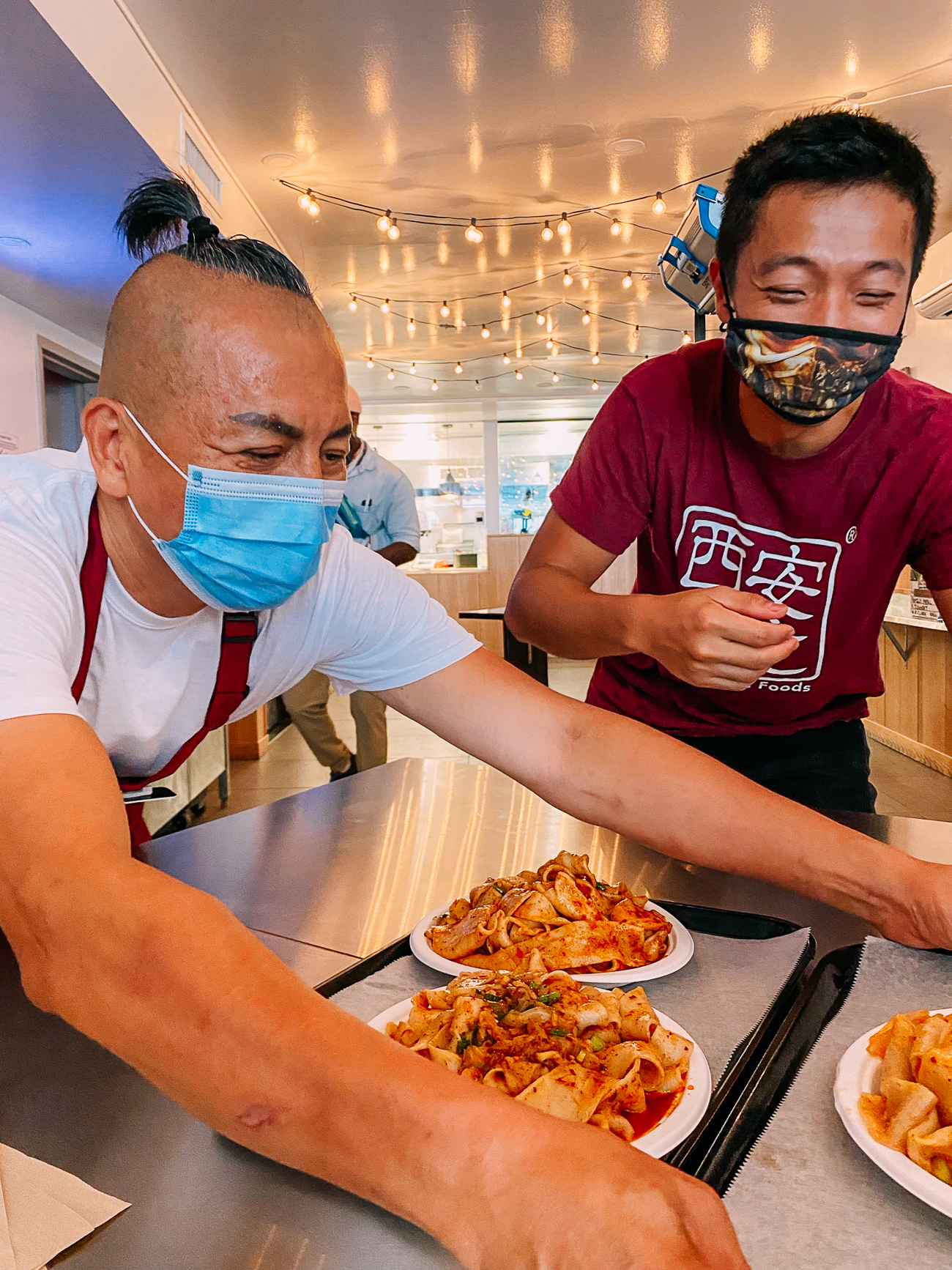 David Shi and Jason Wang serving noodles