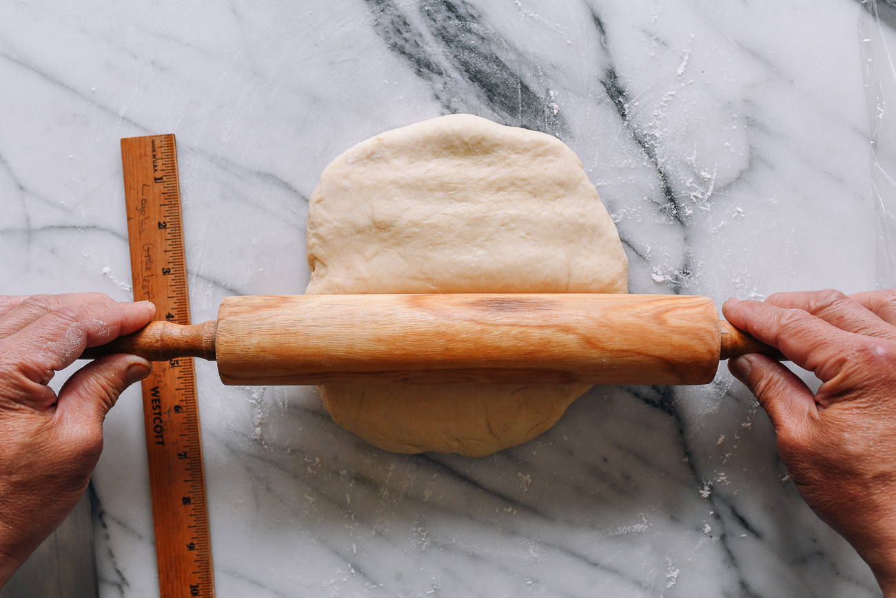 Pressing dough with rolling pin