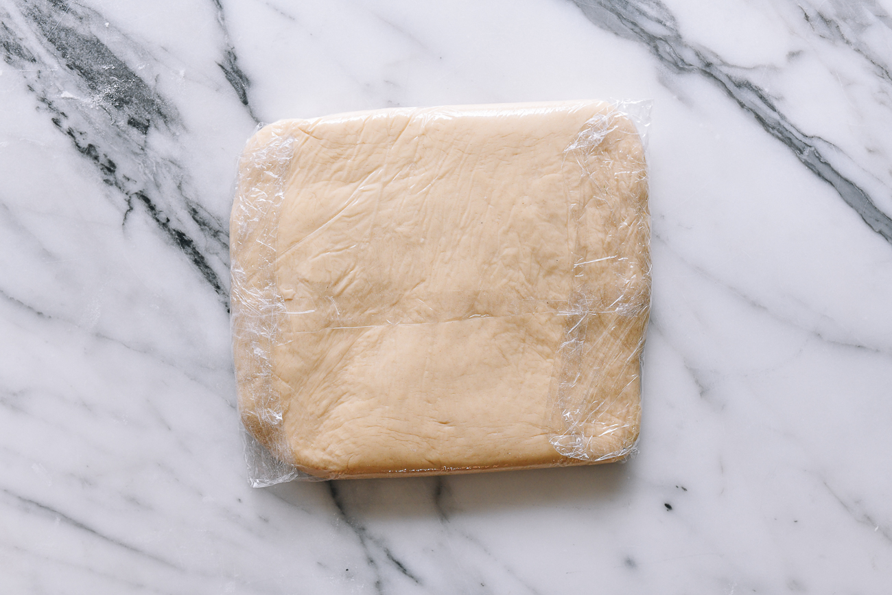 Dough square wrapped in plastic wrap