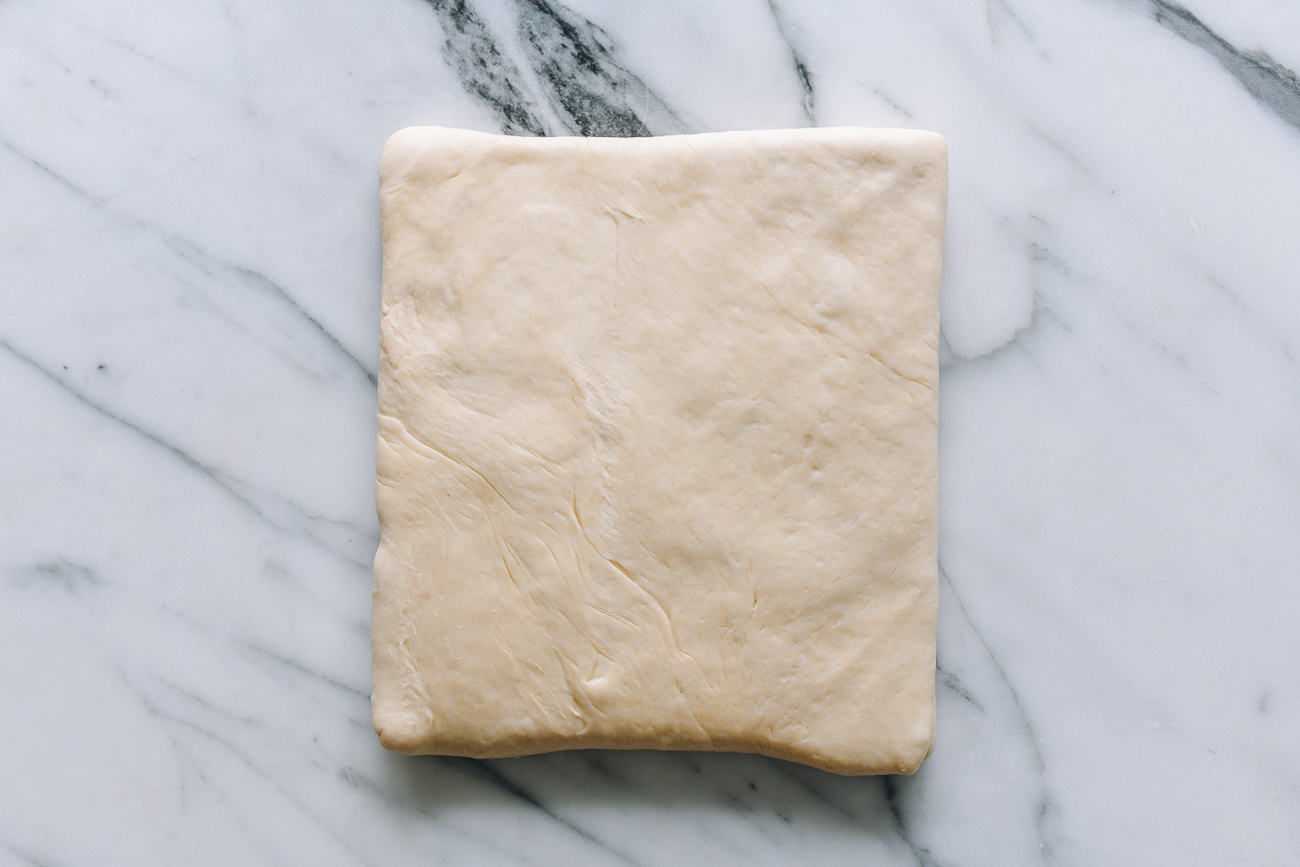 Dough square with butter inside, flipped seam side down
