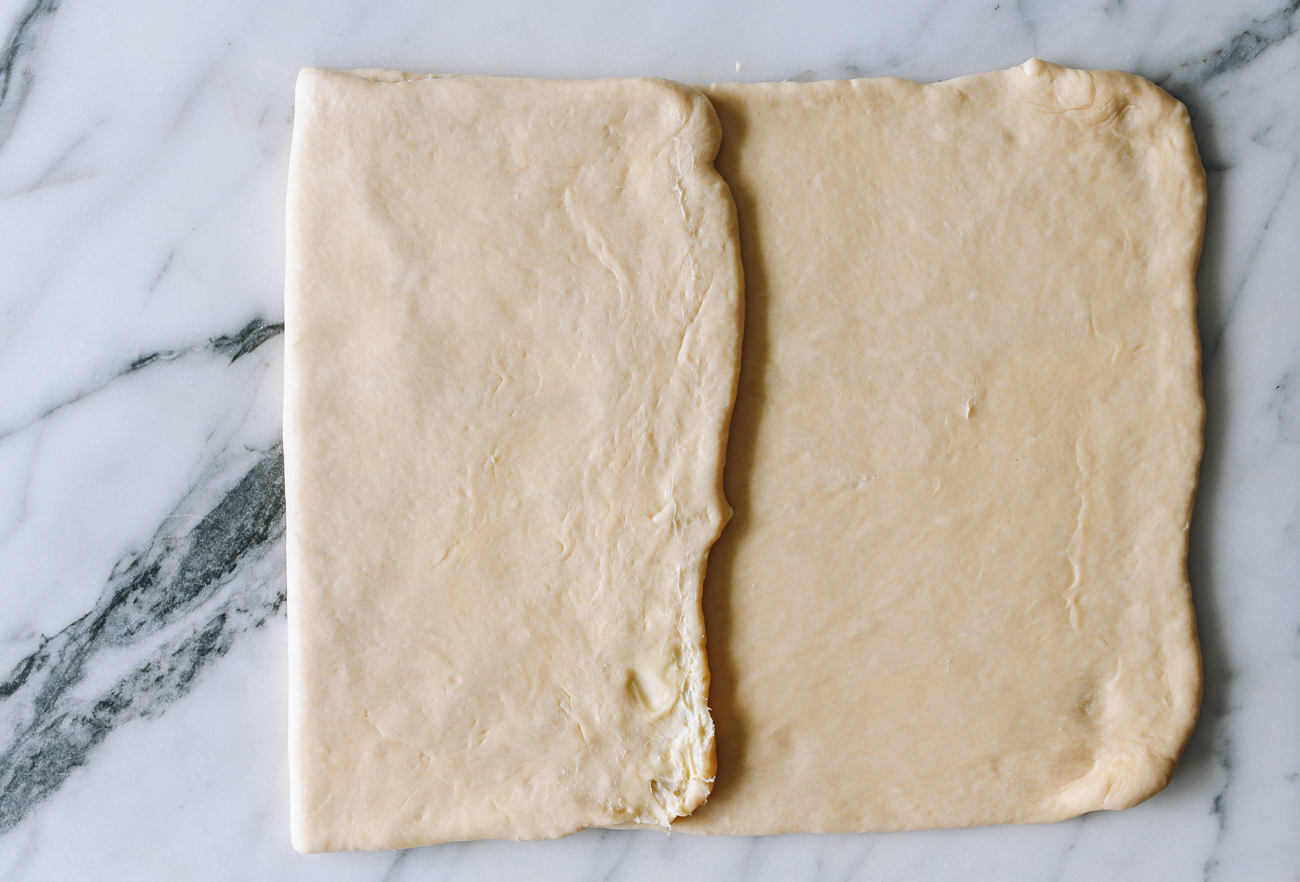 Folding dough rectangle into thirds