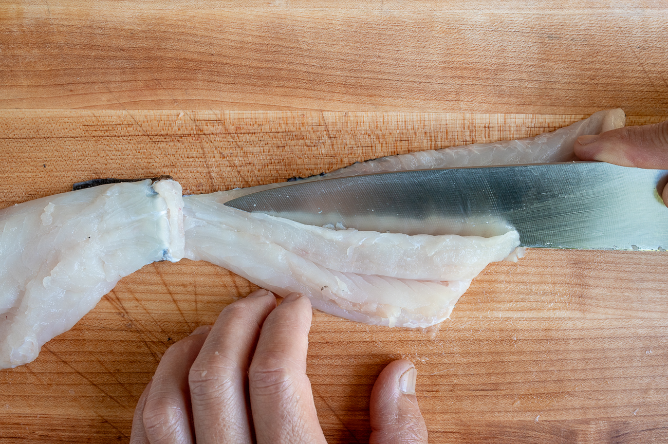 Scoring fish fillets lengthwise at an angle