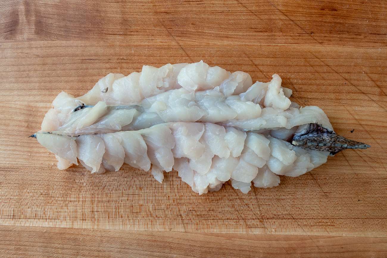 Crosshatch cut fish fillets attached at the tail