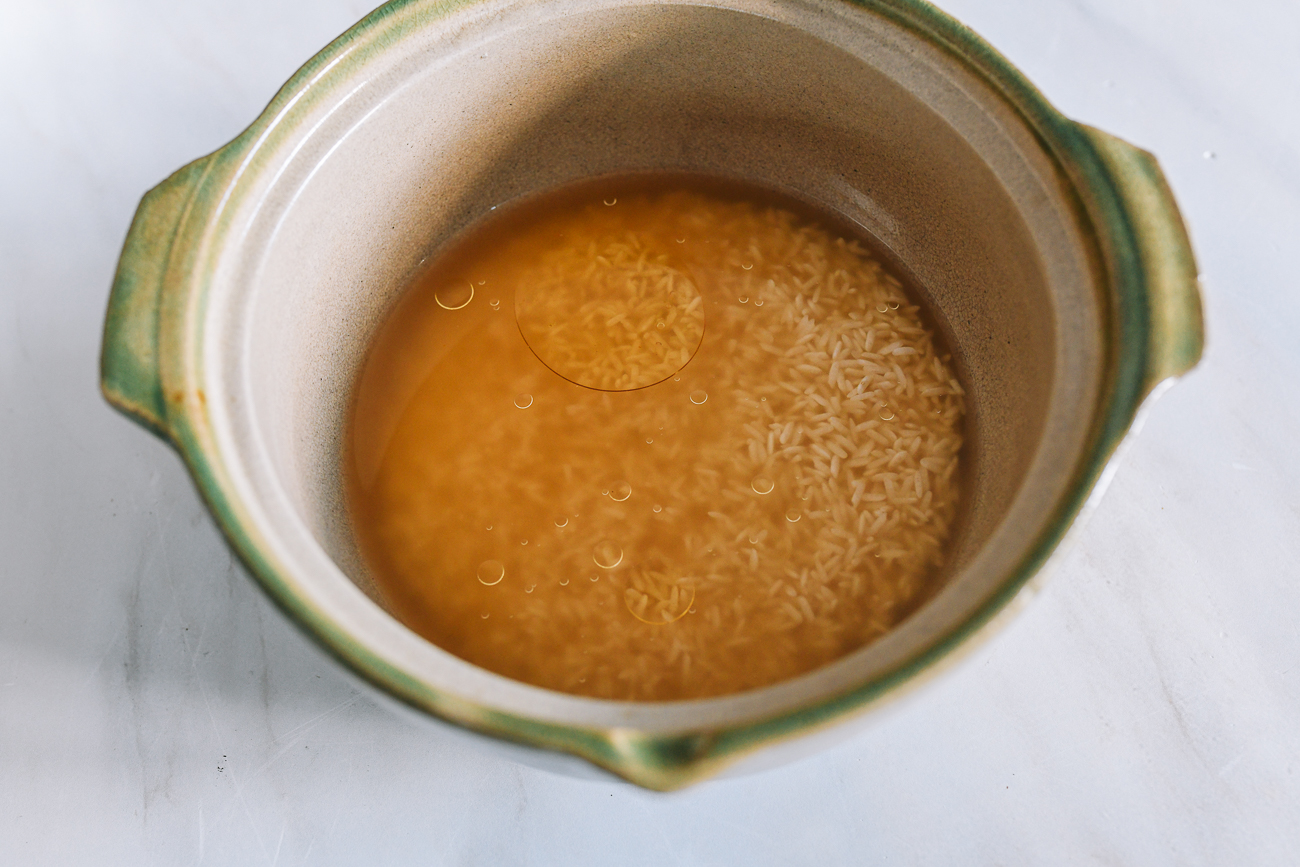 Chicken broth, oil, and salt mixed with soaked rice