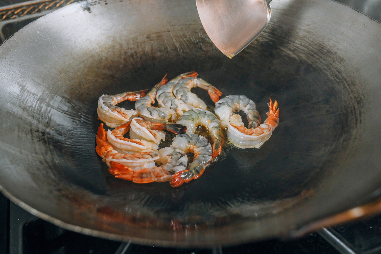 searing tiger shrimp in hot wok