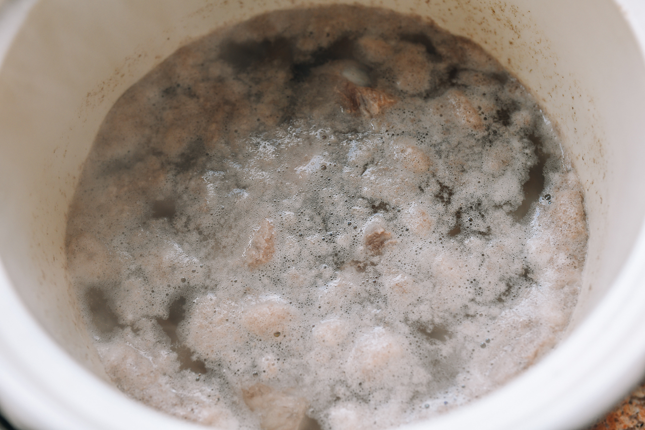 Boiling pork bones to remove impurities