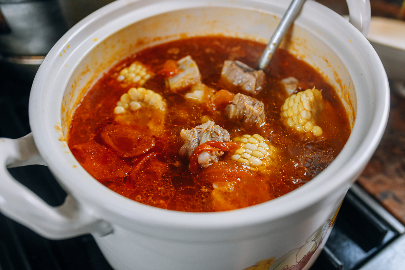 Soup with tomatoes, corn, and pork bones