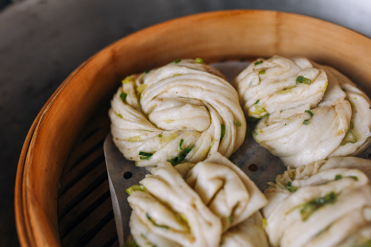 cooked scallion buns in bamboo steamer