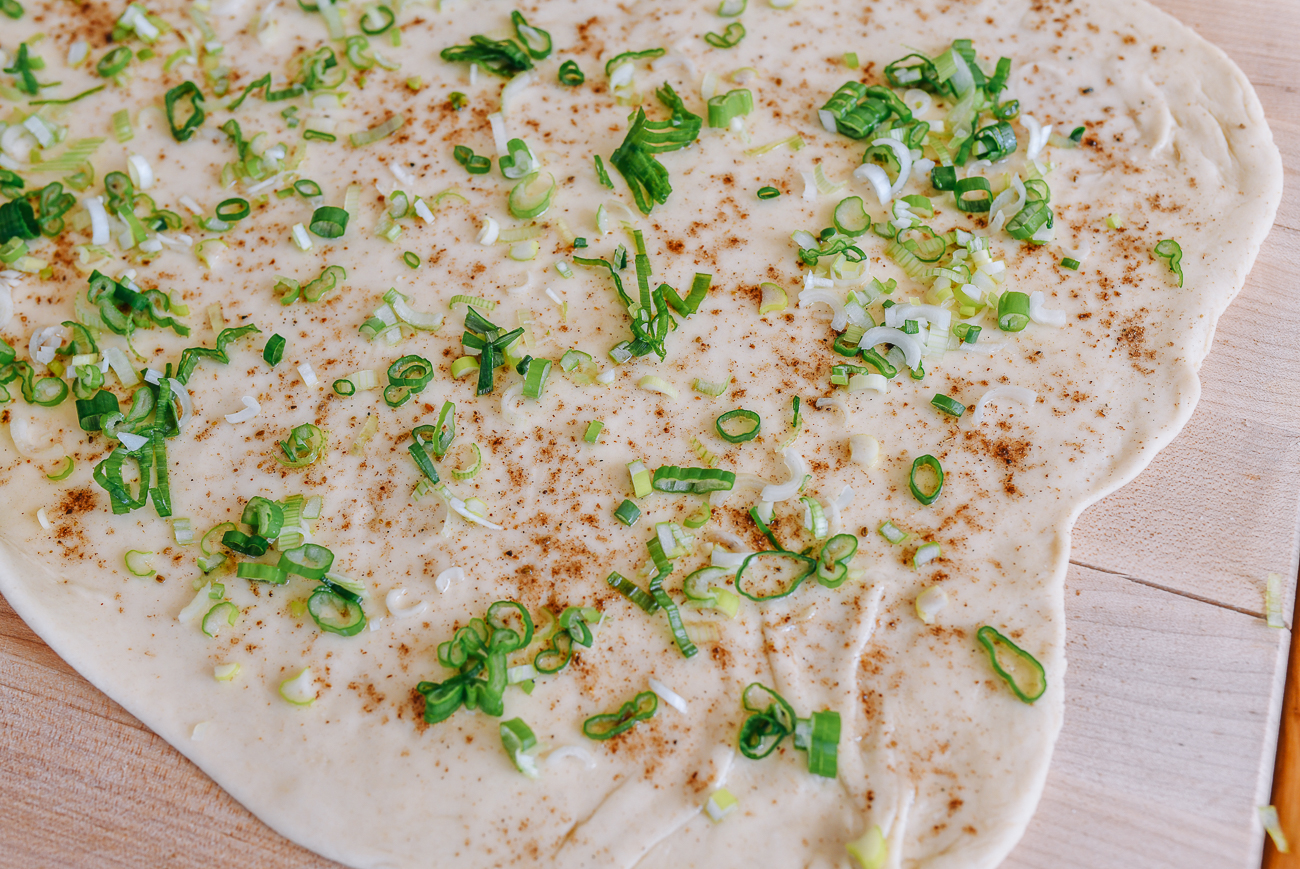dough sprinkled with scallions and seasonings