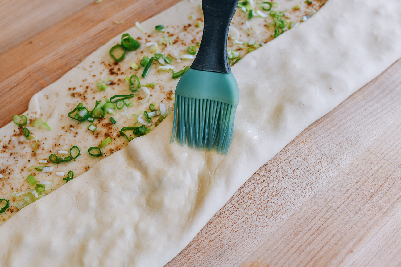 brushing exposed dough with oil
