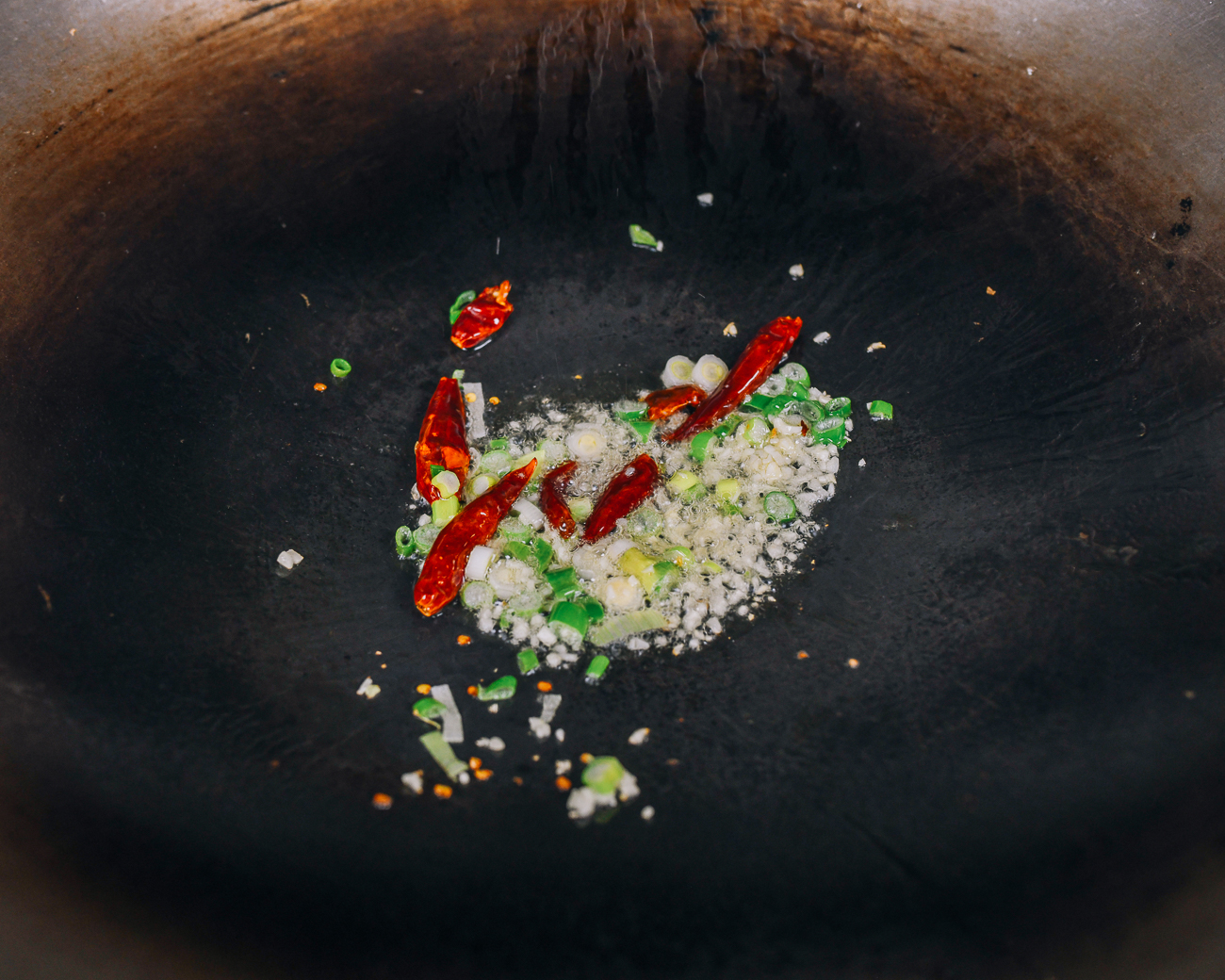 garlic, scallions, and chili in wok