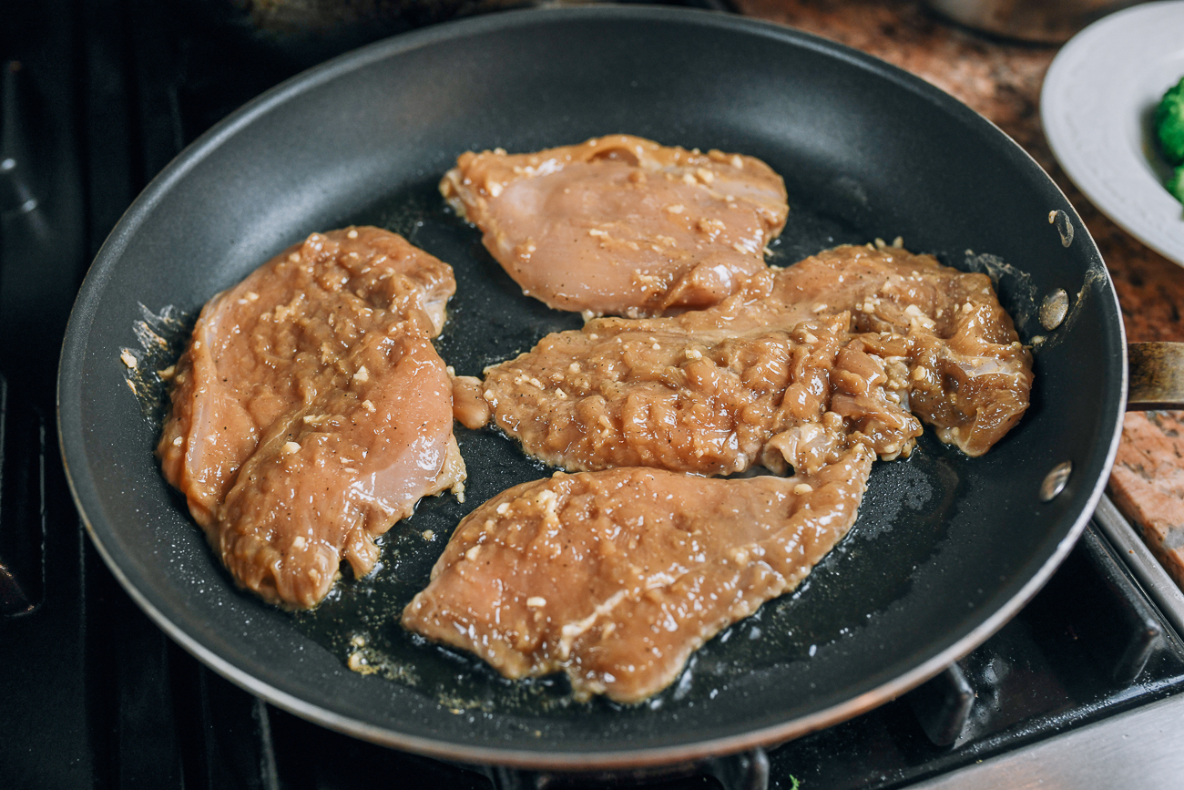 chicken breast pieces in non-stick pan