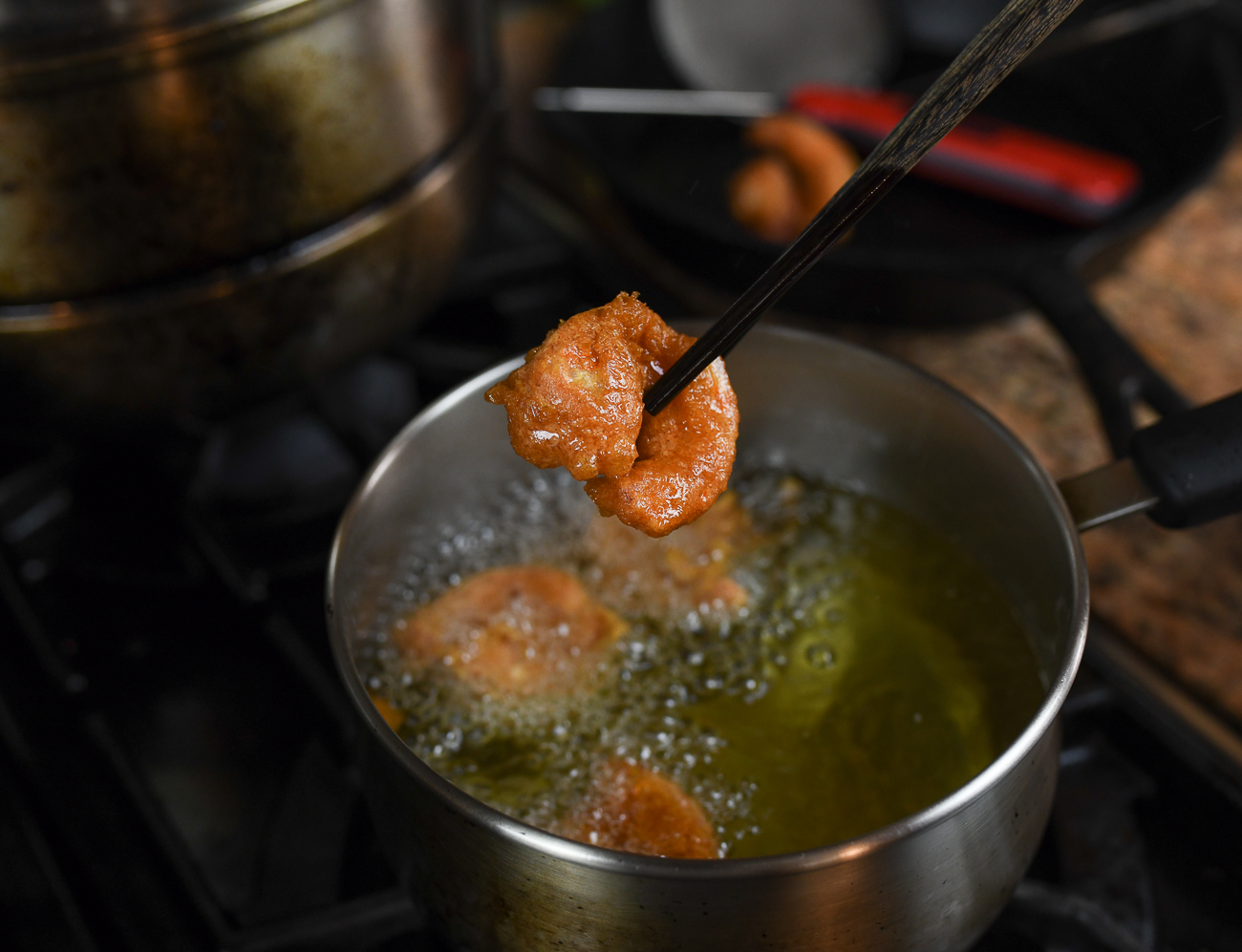 lifting shrimp out of frying oil