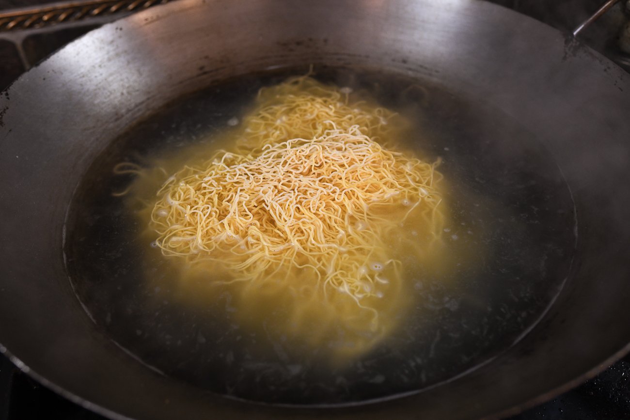 boiling noodles in wok