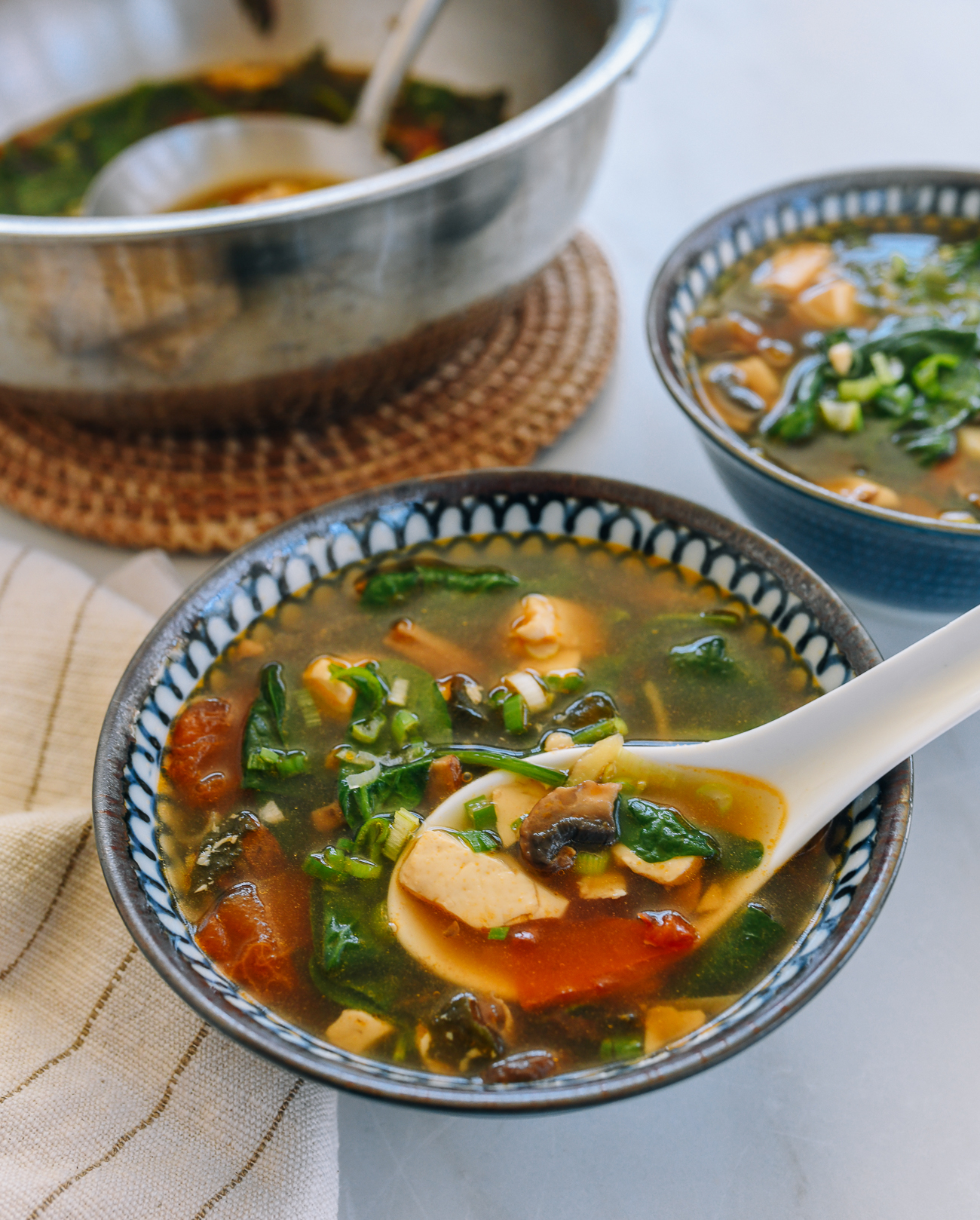 Chinese soup spoon dipped into Vegan Detox Soup