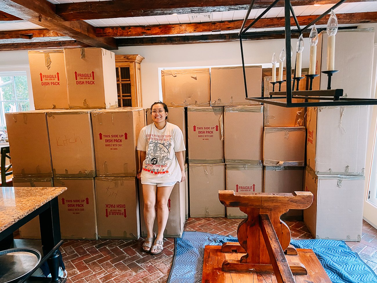 Kaitlin in front of wall of boxes in kitchen