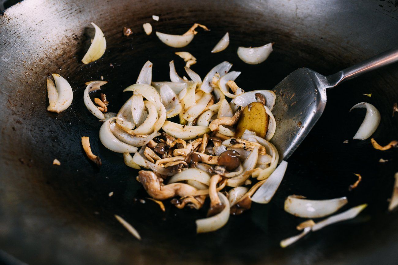 stir-frying oyster mushrooms and onions