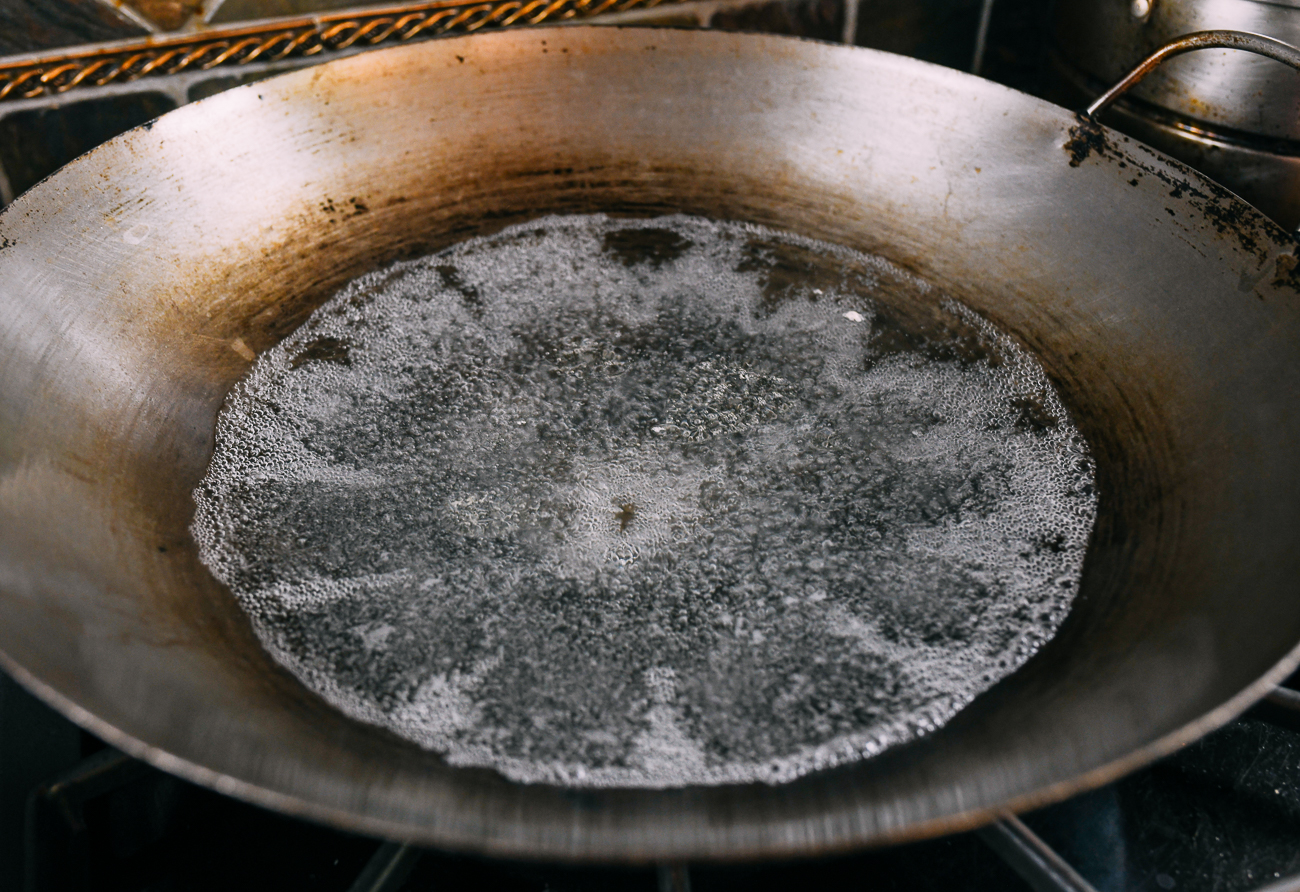 boiling water in wok with some oil