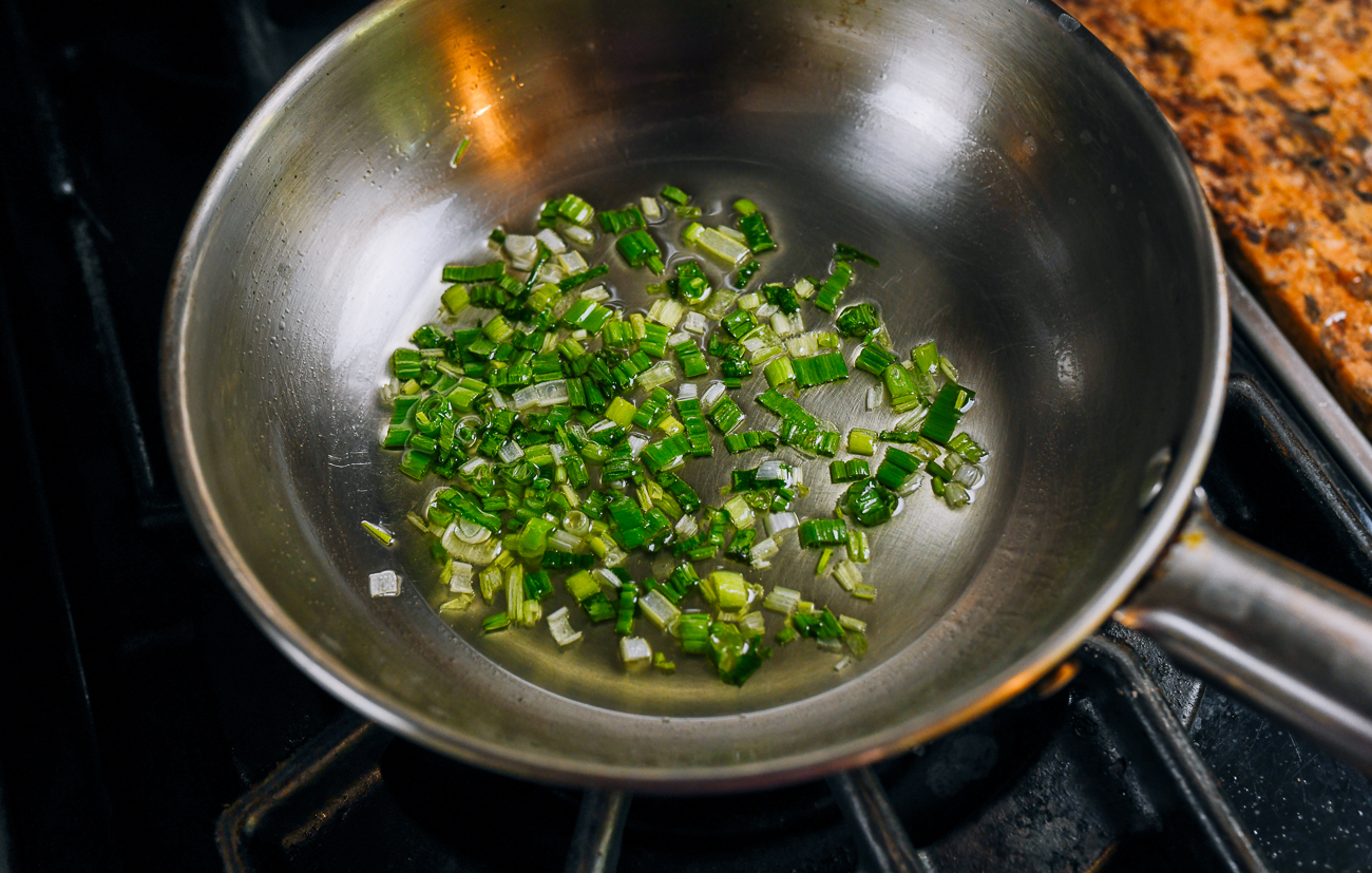 cooking chopped scallions in oil