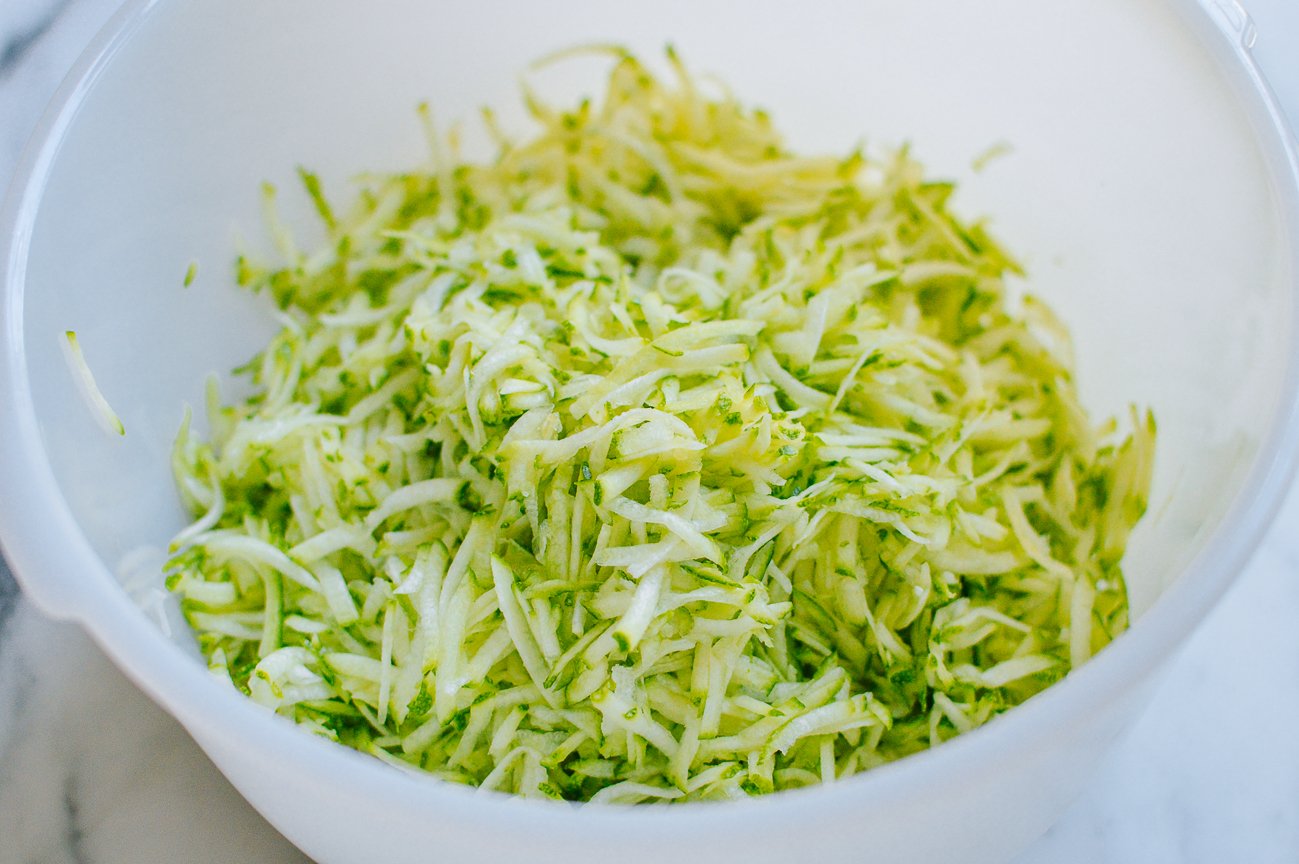 shredded zucchini in white bowl