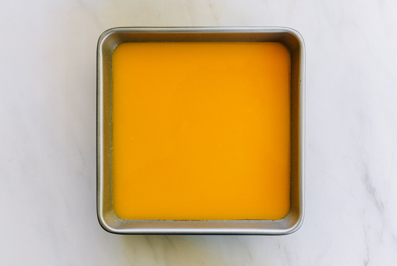 mango pudding mixture in square pan