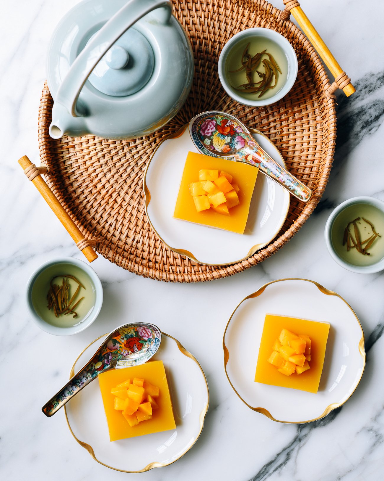 Squares of Mango Pudding on plates with tea