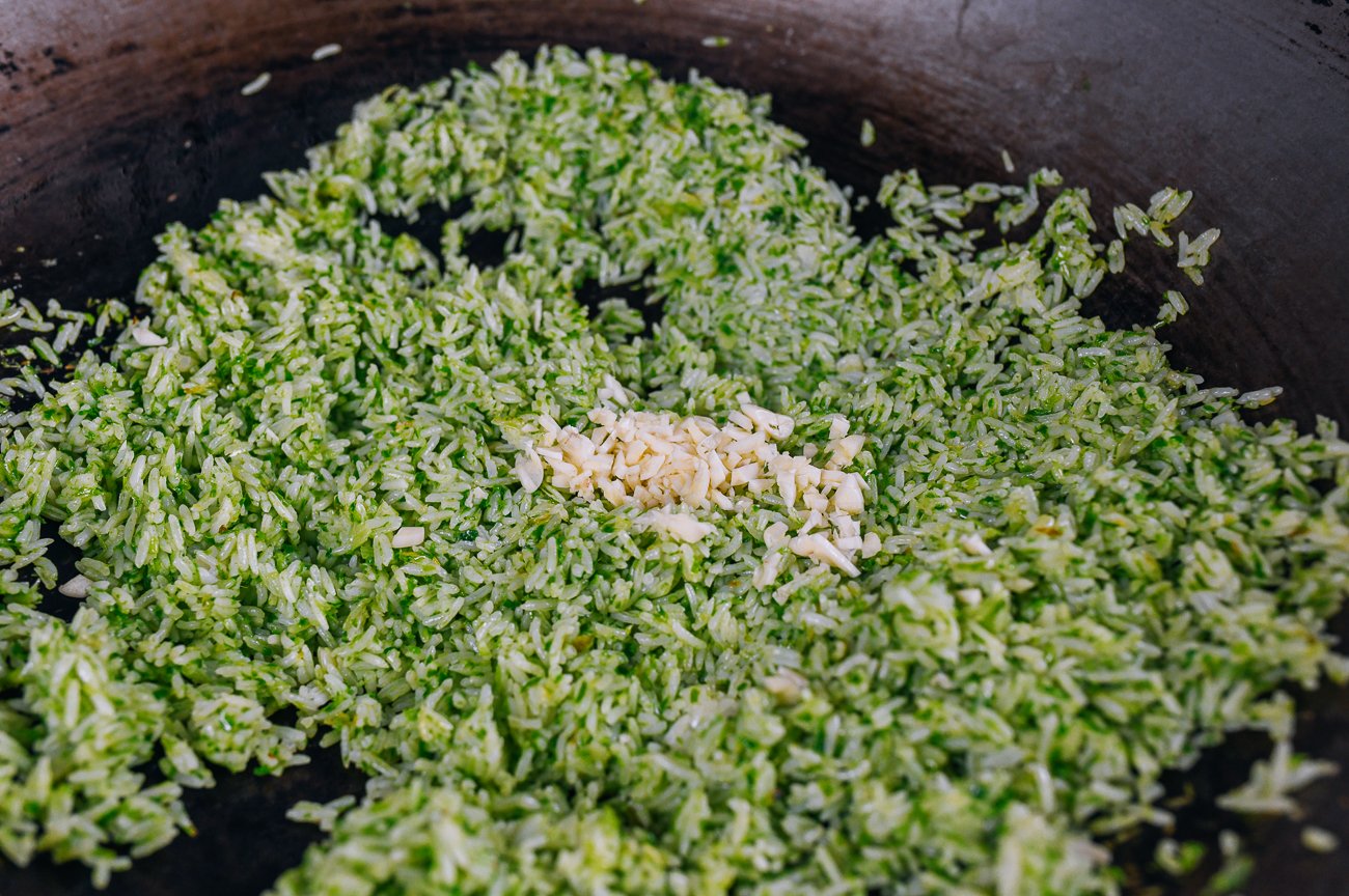 adding garlic to scallion rice