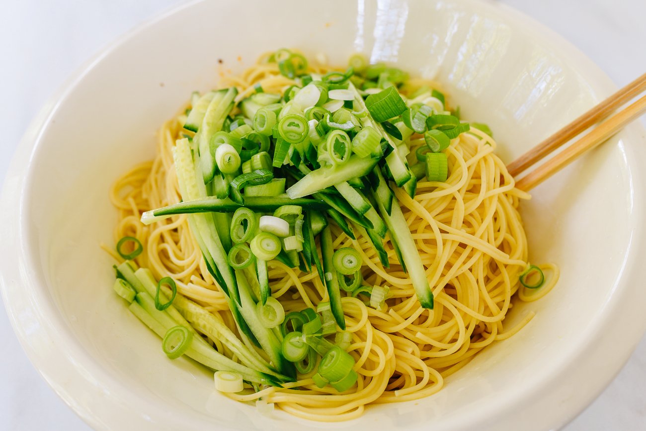 cucumber, scallions and noodles in mixing bowl
