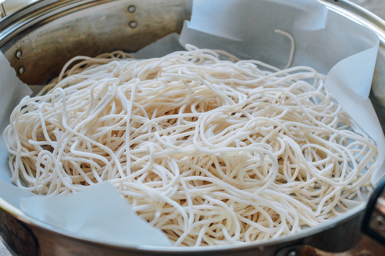 noodles on parchment paper in metal steamer