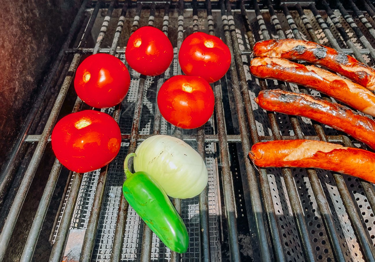 tomatoes, onion, jalapeno on grill with hot dogs