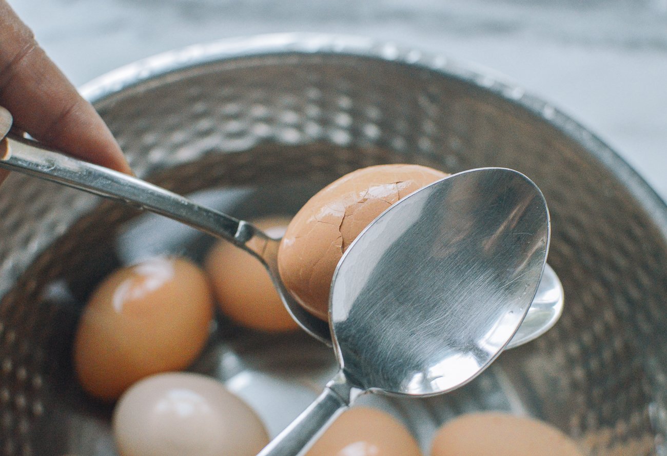 cracking eggs with spoons