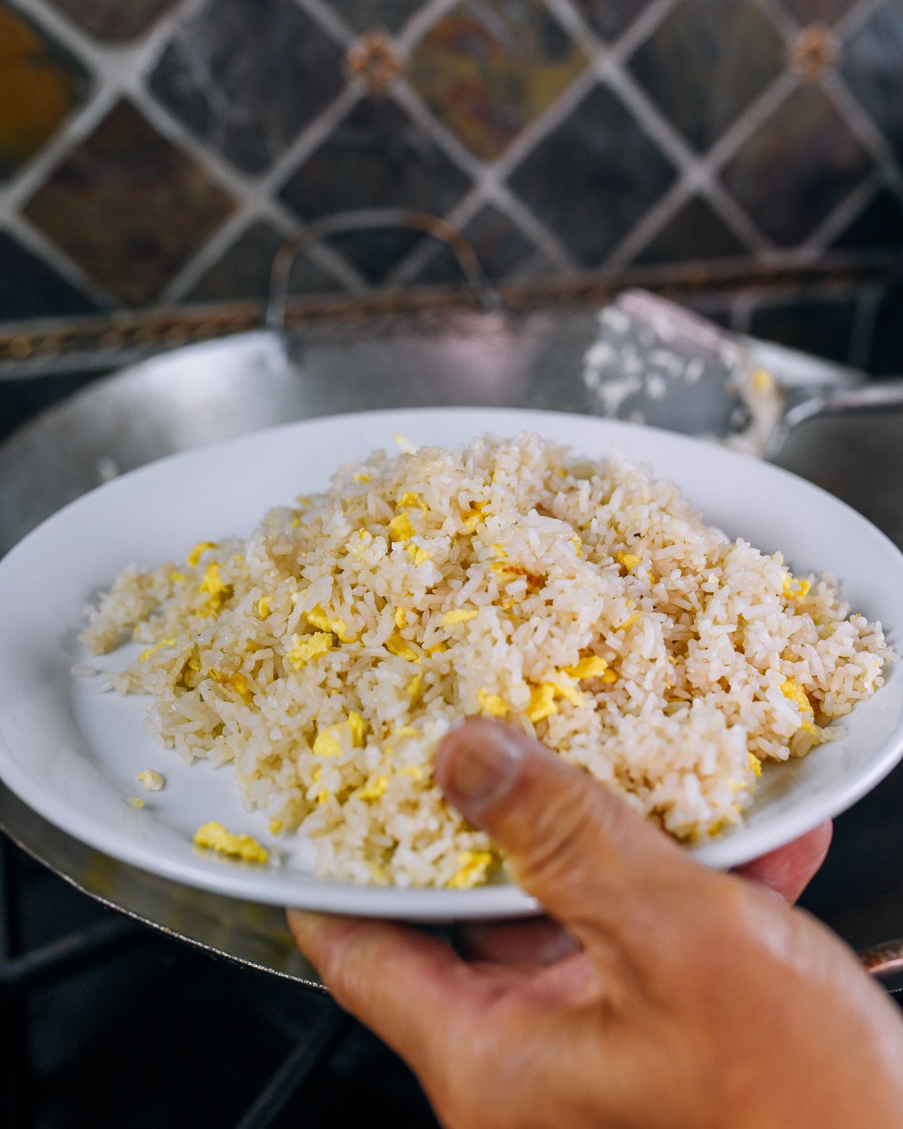 transferring egg fried rice to plate