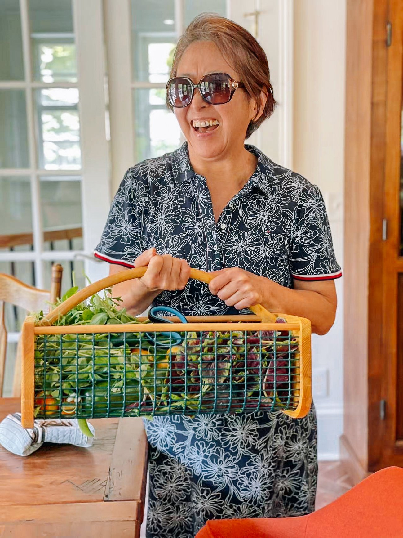 holding harvest basket with leafy greens