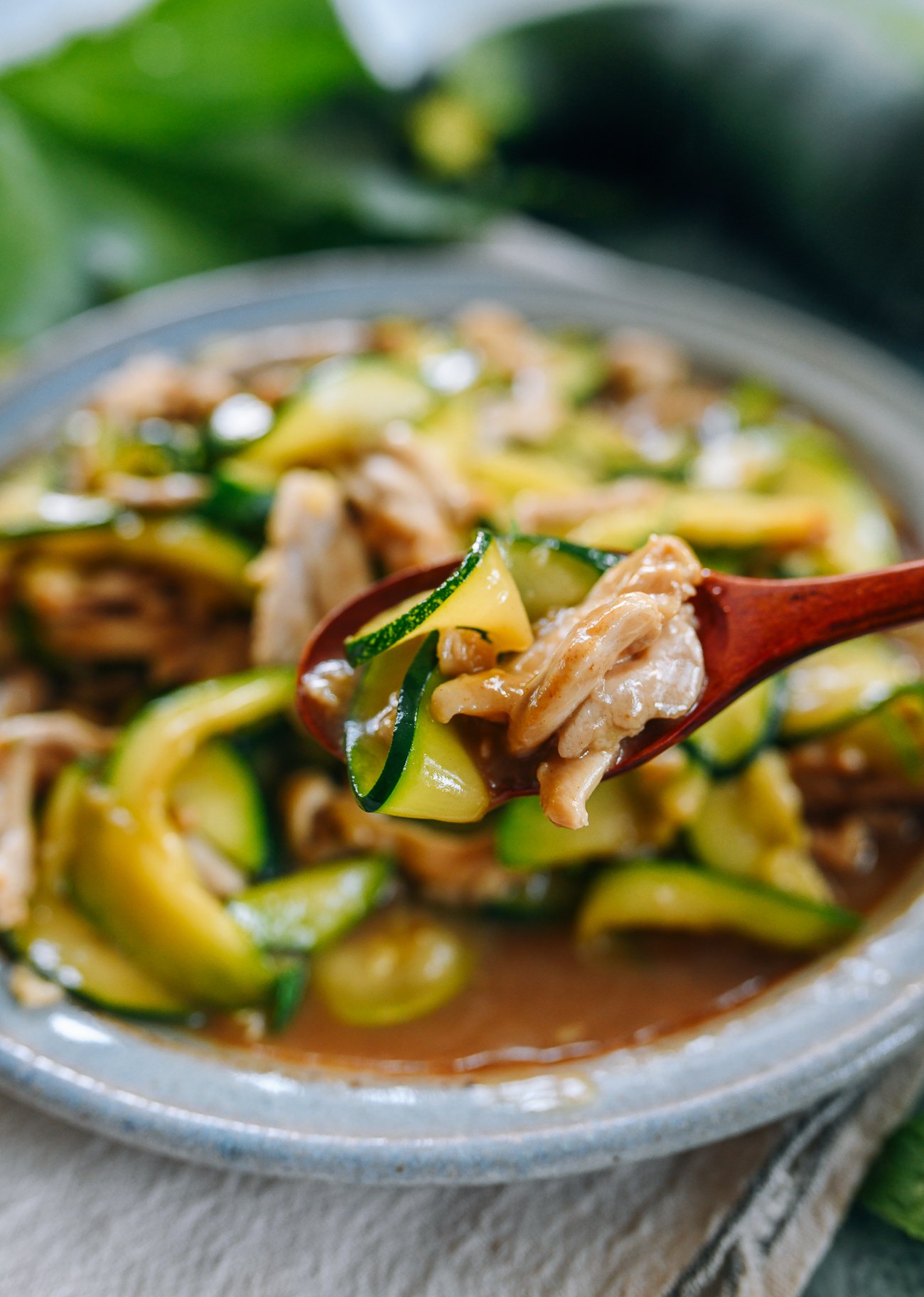 Spoonful of stir-fried zucchini with chicken