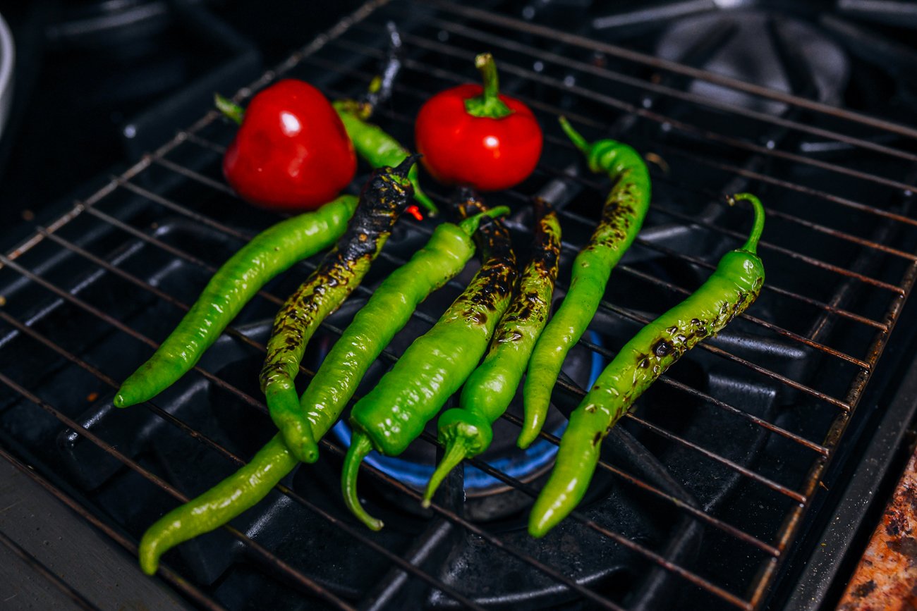 charring peppers over the stove