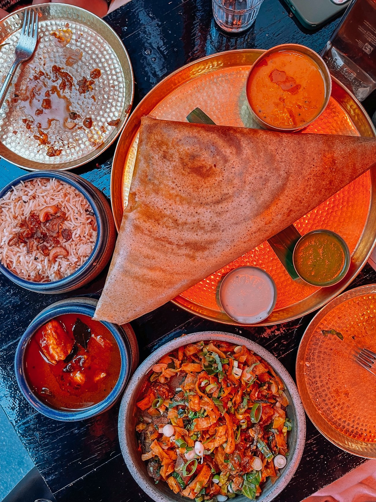 Spread of dosa rice and fish curry