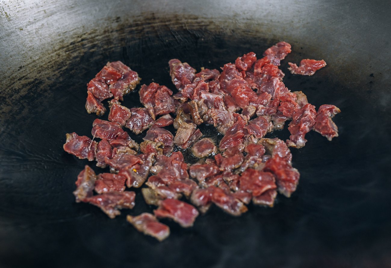searing beef in wok