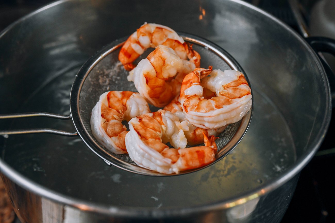 removing cooked shrimp from boiling water