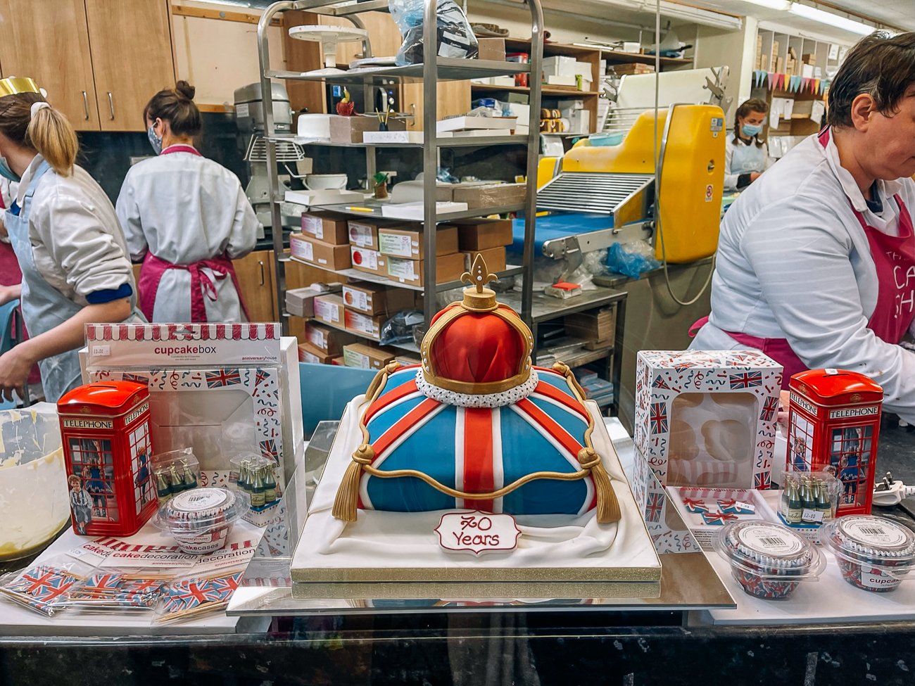 A cake with the UK flag and a red and gold crown on top for the queen's jubilee