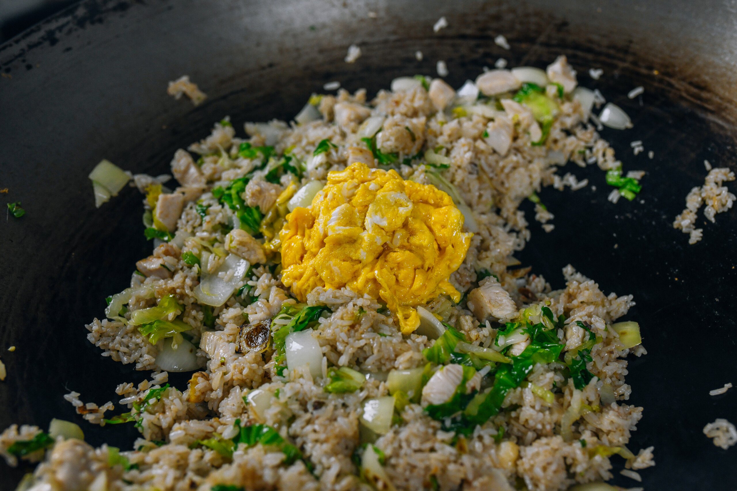 adding eggs to fried rice