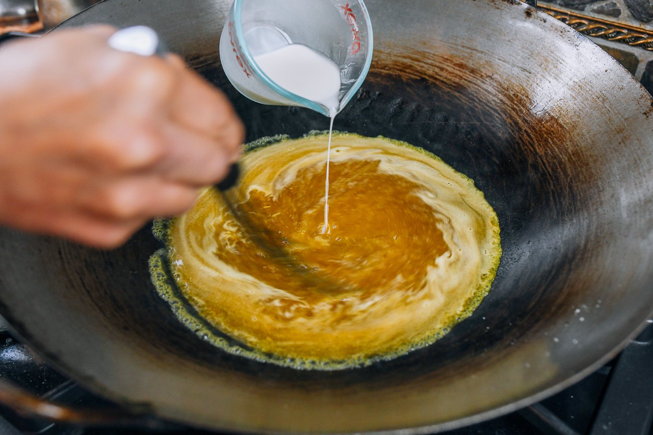 pouring cornstarch slurry into egg foo young gravy to thicken