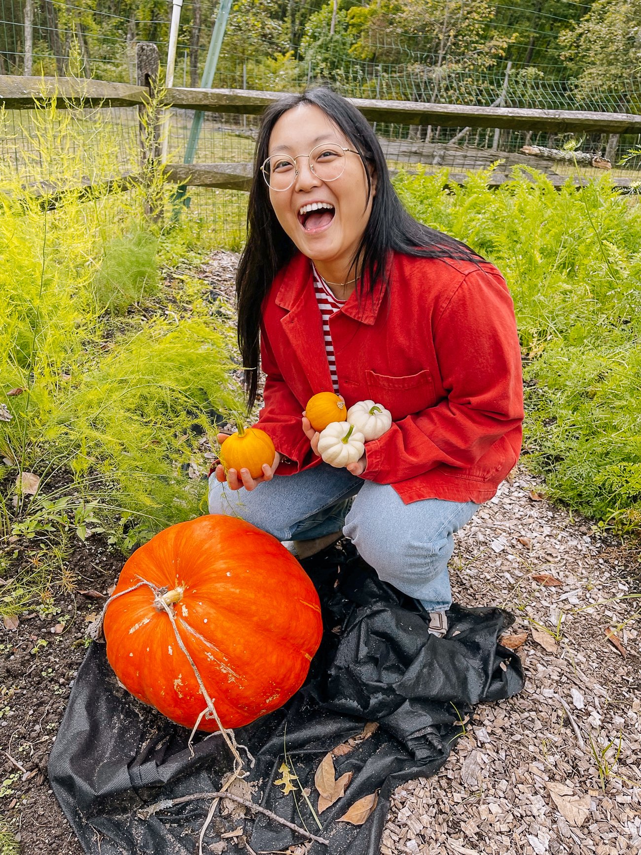Kaitlin with pumpkins in garden