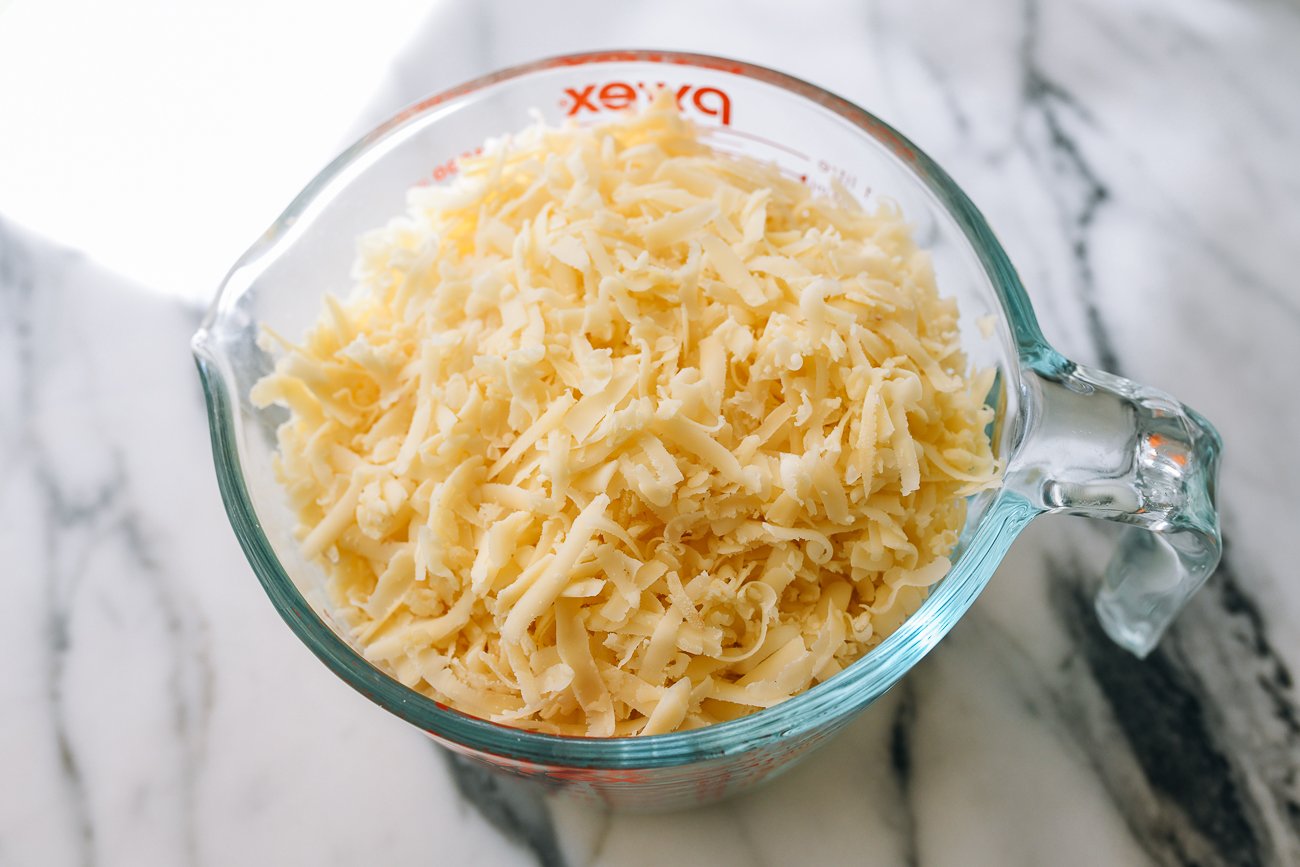 grated cheese in measuring cup