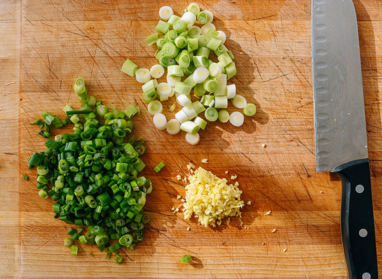 scallions and ginger on cutting board